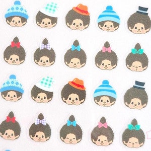 May include: A sheet of 30 colourful stickers featuring the popular cartoon character Monchhichi. The stickers feature Monchhichi wearing different hats and accessories, including a red hat, a blue hat, a green hat, a plaid hat, and a top hat. The stickers are perfect for adding a touch of fun to your planner, journal, or laptop.