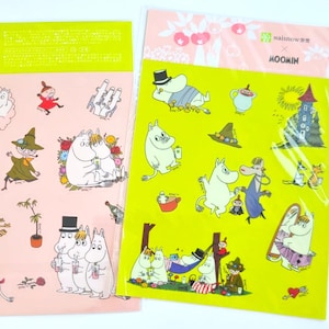 May include: Two sticker sheets featuring cartoon characters. One sheet has a pink background with characters and text in Japanese. The other sheet has a yellow background with various characters and the word "MOOMIN".