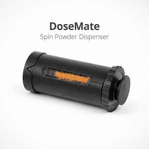 May include: A black DoseMate spin powder dispenser with a small window showing orange powder. The dispenser has a ridged end and a smooth, rounded end. The text "DoseMate Spin Powder Dispenser" is above the dispenser.