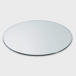 May include: A clear, circular glass tabletop with a beveled edge. The transparent glass reflects light, offering a clean, contemporary aesthetic. Suitable for a dining or coffee table.