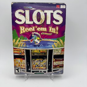 May include: A PC DVD game box for "SLOTS Reel 'em In!" with a vibrant design. The cover shows a cartoon fish leaping from water, with slot machine graphics and the text "Jungle Wild".