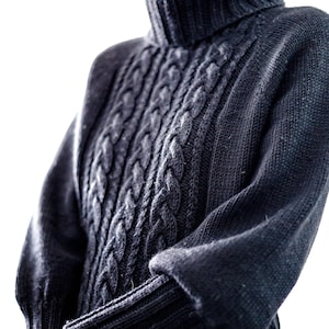 May include: A dark gray cable knit turtleneck sweater with a close-up view of the knit pattern.