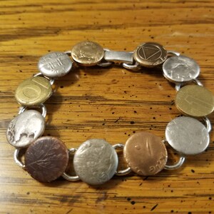 Sterling silver bracelet with coin punch out pieces for the accent pieces. Each one is unique.