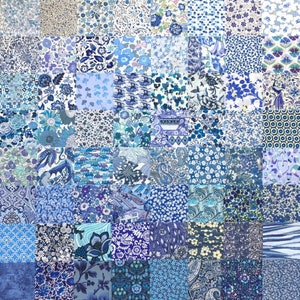 May include: A patchwork quilt made of various blue and white fabrics with floral and geometric patterns.
