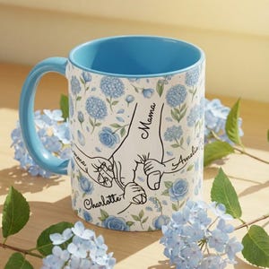 May include: A set of three ceramic mugs with a speckled, matte finish. The mugs are in shades of cream, light gray, and dark gray. Each mug has a simple, minimalist design, perfect for coffee or tea.