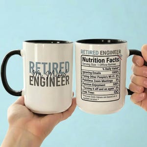 Puede incluir: Una taza de cerámica blanca con asa y borde negros. La taza presenta el texto "RETIRED Mr. Michael ENGINEER" en un lado y una etiqueta de "Nutrition Facts" para un ingeniero jubilado en el otro. La taza está sostenida por una persona.