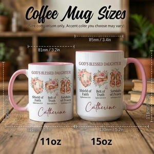 May include: Two white coffee mugs with pink handles and rims, labeled "Coffee Mug Sizes." The mugs feature floral designs and the text "GOD'S BLESSED DAUGHTER." Measurements are provided in inches and ounces. The smaller mug is 3.7 inches tall.