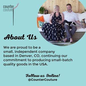 May include: A couple poses on a patio with two dogs. The woman is wearing a black and white dress and the man is wearing a blue shirt and khaki pants. The text "About Us" is in large, bold letters. The text below reads "We are proud to be a small, independent company based in Denver, CO, continuing our commitment to producing small-batch quality goods in the USA. Follow us Online! @CounterCouture".