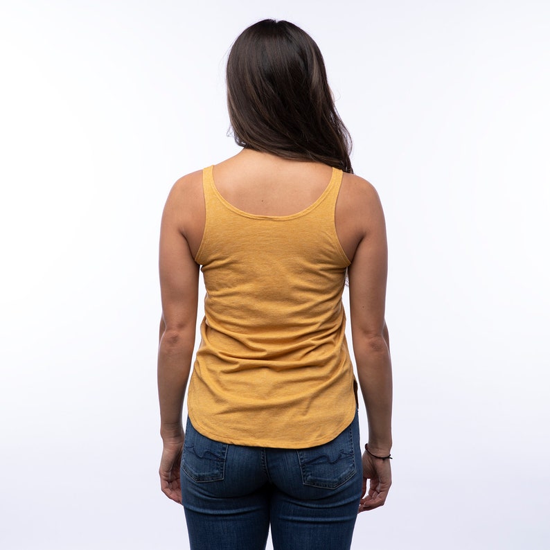 May include: A mustard yellow sleeveless tank top with a scoop neck. The tank top is made of a soft, comfortable fabric and has a relaxed fit.