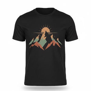 May include: Black t-shirt with a mountain range graphic and a rising sun. The design features mountains in orange, green, and brown, with a golden sun and horizontal lines. A simple, nature-themed design.