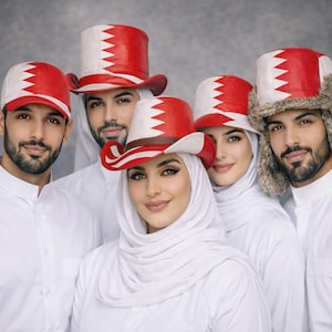 May include: A group of people in white outfits and hats featuring the Bahrain flag. The hats are in various styles, including baseball caps and cowboy hats. The red and white colour scheme is the main focus of the image.