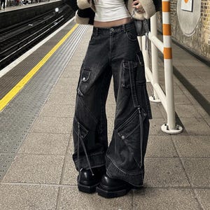 Women's Baggy Cargo Pants | Oversized Loose Washed Denim Jeans | Streetwear Punk Y2k Fashion
.
Women's oversized baggy denim cargo pants with wide-leg fit, zipper details, and multiple pockets — styled for punk and Y2K streetwear fashion.