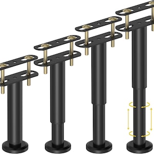 May include: Four black adjustable furniture legs with gold-coloured screws. The legs have a round base and a rectangular top plate with pre-drilled holes for mounting. One leg shows the adjustment feature.