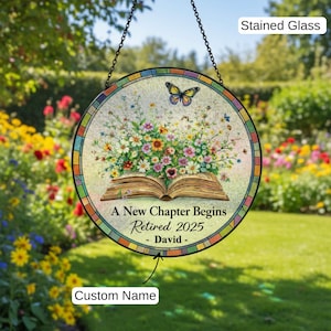 May include: Round stained glass sign with a floral and butterfly design. The sign features an open book with flowers and butterflies. Text reads "A New Chapter Begins Retired 2025 - David - Custom Name".