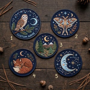 May include: Five circular embroidered patches on a dark blue background. Patch 1 shows an owl on a branch with the text CUSTOM NAME. Patch 2 features a moth. Patch 3 depicts a mountain forest scene. Patch 4 shows a sleeping fox. Patch 5 displays a crescent moon.