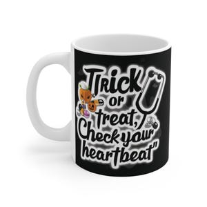 May include: White ceramic mug with a black design. The mug features the text "Trick or treat, Check your heartbeat." The design includes a stethoscope, pumpkins, and pills, ideal for Halloween or medical staff.
