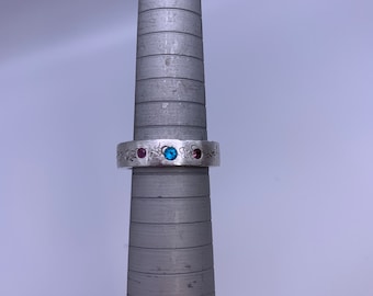 Stamped sterling silver band with pink & blue flush set topaz stones