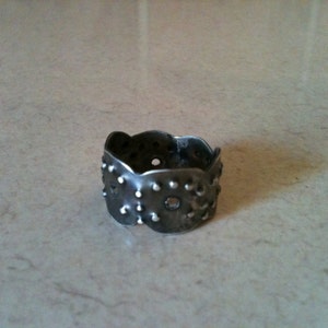 Dark patina sterling silver ring with polished nail punch pattern