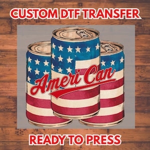 May include: Three aluminum cans with a patriotic design. The cans feature a blue field of white stars and red and white stripes, with the words "Ameri Can" in red script. The text "CUSTOM DTF TRANSFER" and "READY TO PRESS" are in red.