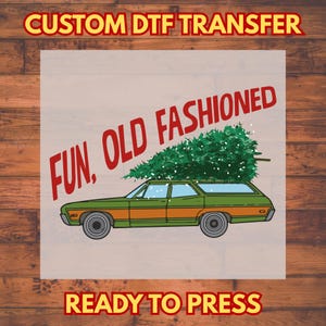 May include: A DTF transfer design showing a green and orange estate car with a Christmas tree on its roof. The text "FUN, OLD FASHIONED" is in red, with "READY TO PRESS" and "CUSTOM DTF TRANSFER" in yellow.