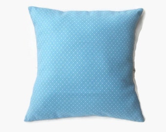 May include: A light blue throw pillow with a white diamond pattern.