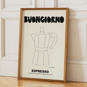 May include: A rectangular framed wall art print featuring a cream background with a black line drawing of a moka pot. The text BUONGIORNO appears at the top in bold black letters, with ESPRESSO and the phrase in qualsiasi momento, in qualsiasi giorno below.