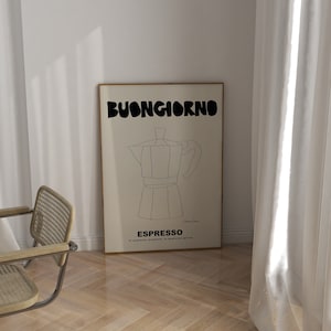 May include: A rectangular framed wall art print featuring a cream background with a black line drawing of a moka pot. The text BUONGIORNO is printed in large black letters at the top, with ESPRESSO and smaller Italian text printed below the drawing.