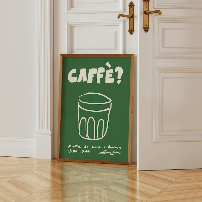 May include: A white ceramic mug with a black handle and the text "But First, Coffee" in a bold, black font. The mug is set against a blurred background, highlighting its simple design.