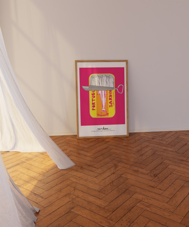 May include: A framed rectangular art print featuring a vibrant pink background with a yellow sardine tin illustration. The tin shows silver sardines, a metal lid, and the text PORTUGUESE SARDINES. The bottom text reads sardines straight from Portugal.