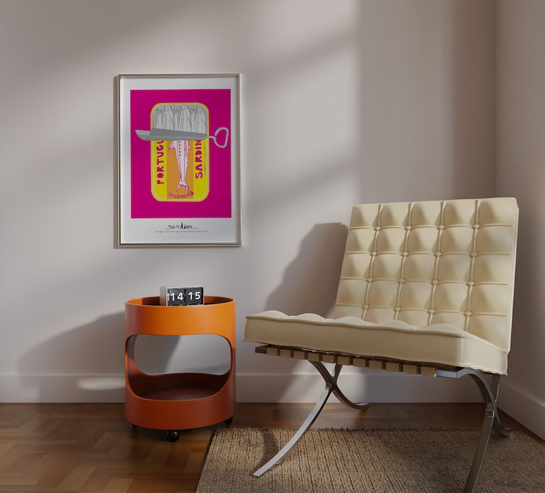 May include: A framed wall art print featuring a vibrant magenta background with a yellow sardine tin graphic. The tin displays the text PORTUGUESE SARDINES and a stylized fish illustration. Below the tin, the word sardines is printed in black text.