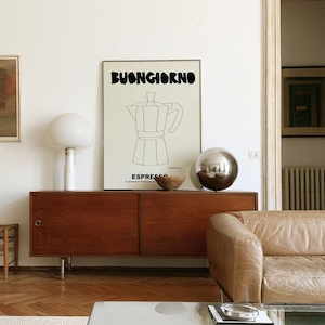 May include: A rectangular wall art print featuring the black text BUONGIORNO at the top and ESPRESSO at the bottom, with a central black line drawing of a moka pot coffee maker on a light cream background, framed in a thin metallic border.