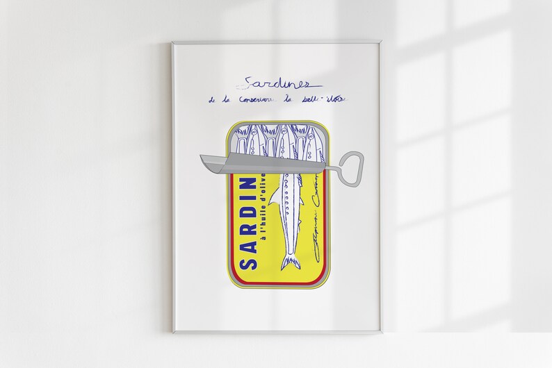 Chic Hand-drawn minimalist kitchen and bar cart print "Sardines" art print poster by KunstbyStephie. A framed print of a yellow sardine can with a blue and white label that reads 'SARDIN à l'huile d'olive.' The can is partially open with a silver can opener. The print has the words 'Sardines de la Conserverie le Boll - île' written in blue ink at the top.