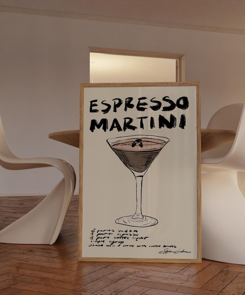 May include: A framed print with an Espresso Martini illustration. The artwork displays the words "ESPRESSO MARTINI" in bold, black lettering. The recipe is listed below the cocktail image: vodka, espresso, coffee liqueur, and simple syrup.