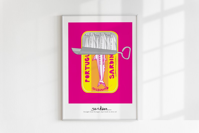 May include: A framed art print featuring a stylized yellow tin of sardines against a vibrant magenta background. The tin shows a silver sardine illustration with the text PORTUGUESE SARDINES and the word sardines with the phrase Straight from Portugal, kept fresh in olive oil.