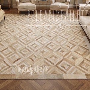 May include: A large, rectangular rug with a geometric pattern in shades of beige and brown. The rug features a repeating diamond and square design, creating a textured appearance. The rug is surrounded by a border and is suitable for a living room or similar space.