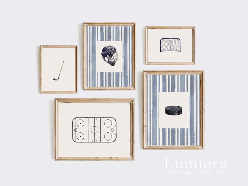 May include: A set of five framed prints featuring hockey-themed illustrations. The prints include a hockey stick, a helmet, a net, a hockey puck, and a hockey rink. The frames have a light wood finish and are arranged on a white wall.