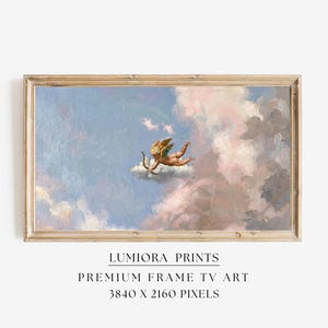 May include: A framed print featuring a classical painting of a cherub with a bow and arrow, floating on a cloud in a sky filled with pastel-colored clouds. The frame is a light brown color. The text at the bottom reads "LUMIRA PRINTS PREMIUM FRAME TV ART 3840 X 2160 PIXELS."