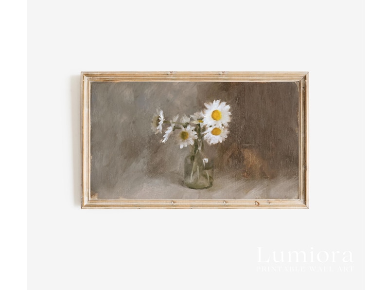 May include: A framed vintage-style print featuring a still life of daisies in a clear glass vase. The daisies have white petals and yellow centers. The background is a muted, neutral color palette. The frame is a light brown color.
