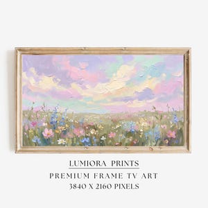 以下が含まれることがあります： パステルカラーの空と野花が咲く野原を描いた、額装された風景画。柔らかい筆致と木製のフレームが特徴です。「LUMIRA PRINTS」と「PREMIUM FRAME TV ART」の文字が見えます。