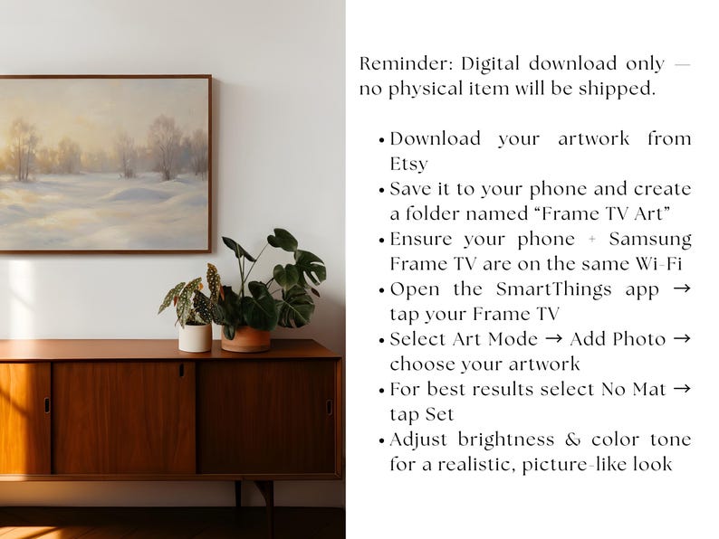 May include: A framed landscape painting depicting a snowy field and trees under a soft, golden sky. The artwork hangs above a mid-century modern wooden cabinet with potted plants. The image includes instructions for downloading artwork from Etsy.