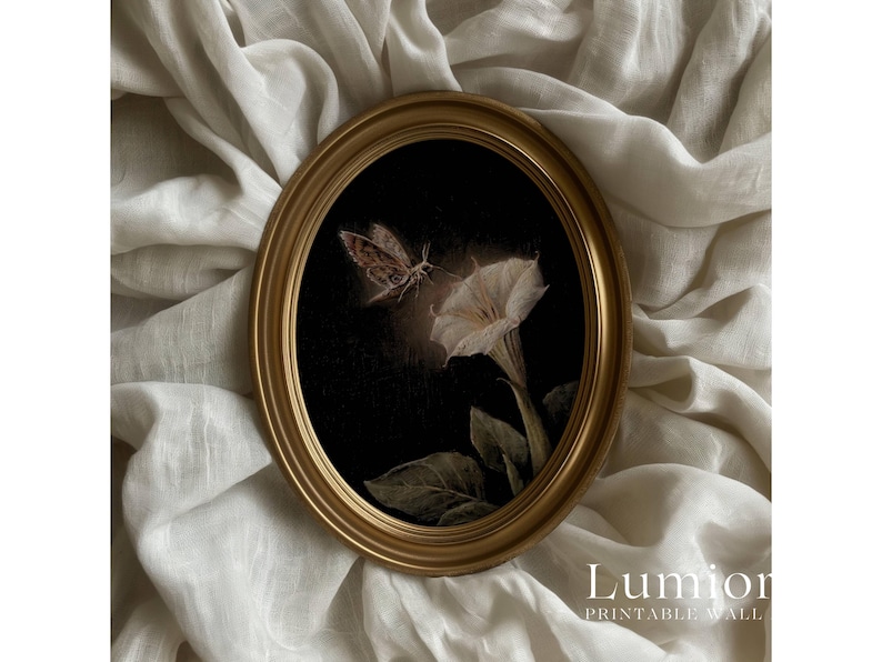 May include: An oval, gold-framed print depicting a moth and a white flower on a dark backdrop. The artwork has a vintage style, with the text "Lumion Printable Wall" at the bottom. The print is set against a backdrop of draped, off-white fabric.