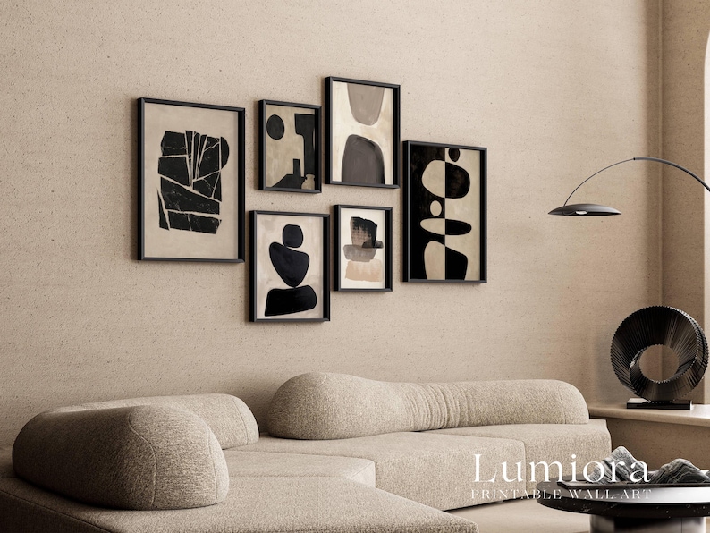 May include: A gallery wall set of six framed prints featuring black and beige abstract shapes and geometric patterns. The collection includes various rectangular frames arranged in a cluster, displaying contrasting dark forms against light backgrounds.
