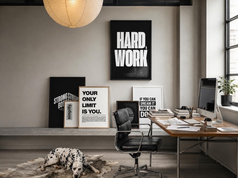 May include: A home office featuring a black framed poster with the text HARD WORK, a white framed poster with the text YOUR ONLY LIMIT IS YOU, and a white framed poster with the text IF YOU CAN DREAM IT YOU CAN DO IT, alongside a black office chair.