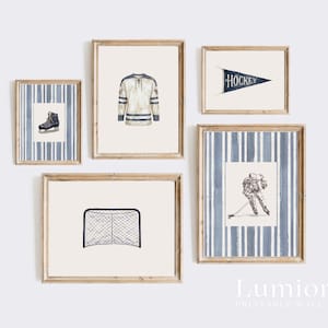 May include: A collection of framed wall art featuring hockey-themed illustrations. The set includes a hockey jersey, a hockey skate, a hockey net, a pennant with the word "HOCKEY", and a hockey player in action. The frames have a light wood finish.