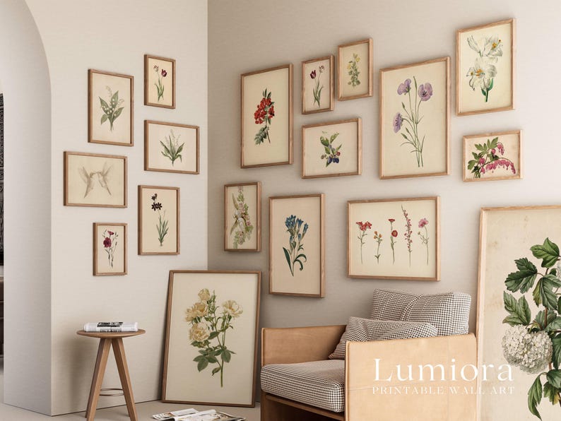 May include: A collection of framed botanical prints in various sizes, featuring detailed illustrations of flowers in shades of red, purple, white, and blue. The prints are displayed on a neutral-colored wall, creating a gallery-like arrangement.