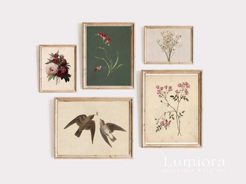 May include: A collection of framed botanical prints featuring floral and bird illustrations. The prints showcase various flowers, including red blooms, pink roses, and delicate white flowers, with a pair of birds. The frames are a light wood color.