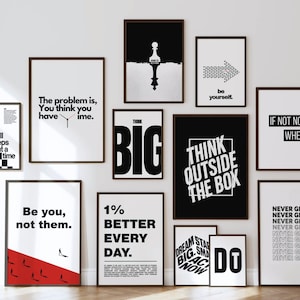 May include: A gallery wall collection of twelve framed posters featuring black and white motivational typography and graphic designs, including phrases like Think Outside The Box, Be You, Not Them, and Never Give Up, arranged in a grid layout.