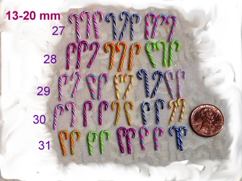 May include: A collection of 20 miniature candy canes in various colors, including pink, purple, blue, green, orange, and yellow. The candy canes are arranged in rows and numbered 27 through 31. A US penny is included for scale, measuring 13-20 mm.