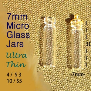 May include: Two clear glass jars with gold lids. The jars are 7mm in diameter and 30mm tall. The text on the image reads "7mm Micro Glass Jars Ultra Thin 4/$3 10/$5".