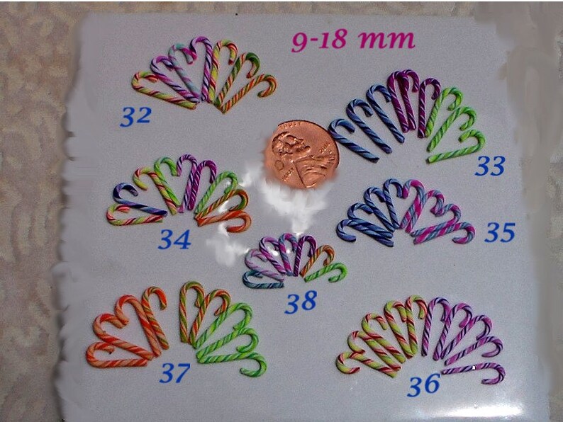 May include: Assortment of 10 miniature candy canes in various colors and patterns, measuring 9-18 mm. The candy canes are arranged in groups of 2-3, labeled with numbers 32, 33, 34, 35, 36, 37, 38.